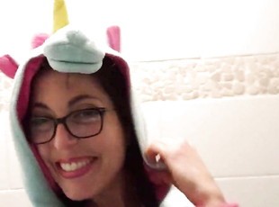Girl in unicorn onesie change her tampon