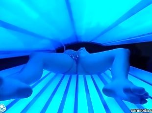 Teen latina college student gives lesbian pussy a massage in tanning bed