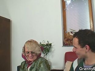 Blonde mature granny rides a young stud's cock