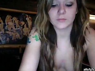 Girl with a tattoo on his arm communicates via webcam